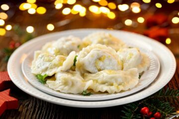 Christmas dumplings stuffed with mushroom and cabbage on a white
