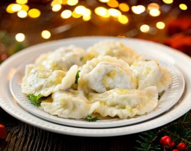 Christmas dumplings stuffed with mushroom and cabbage on a white